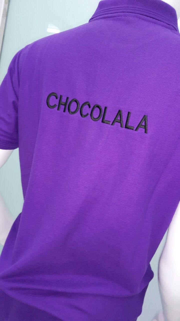 Back of a purple polo shirt printed with the word 'CHOCOLALA'