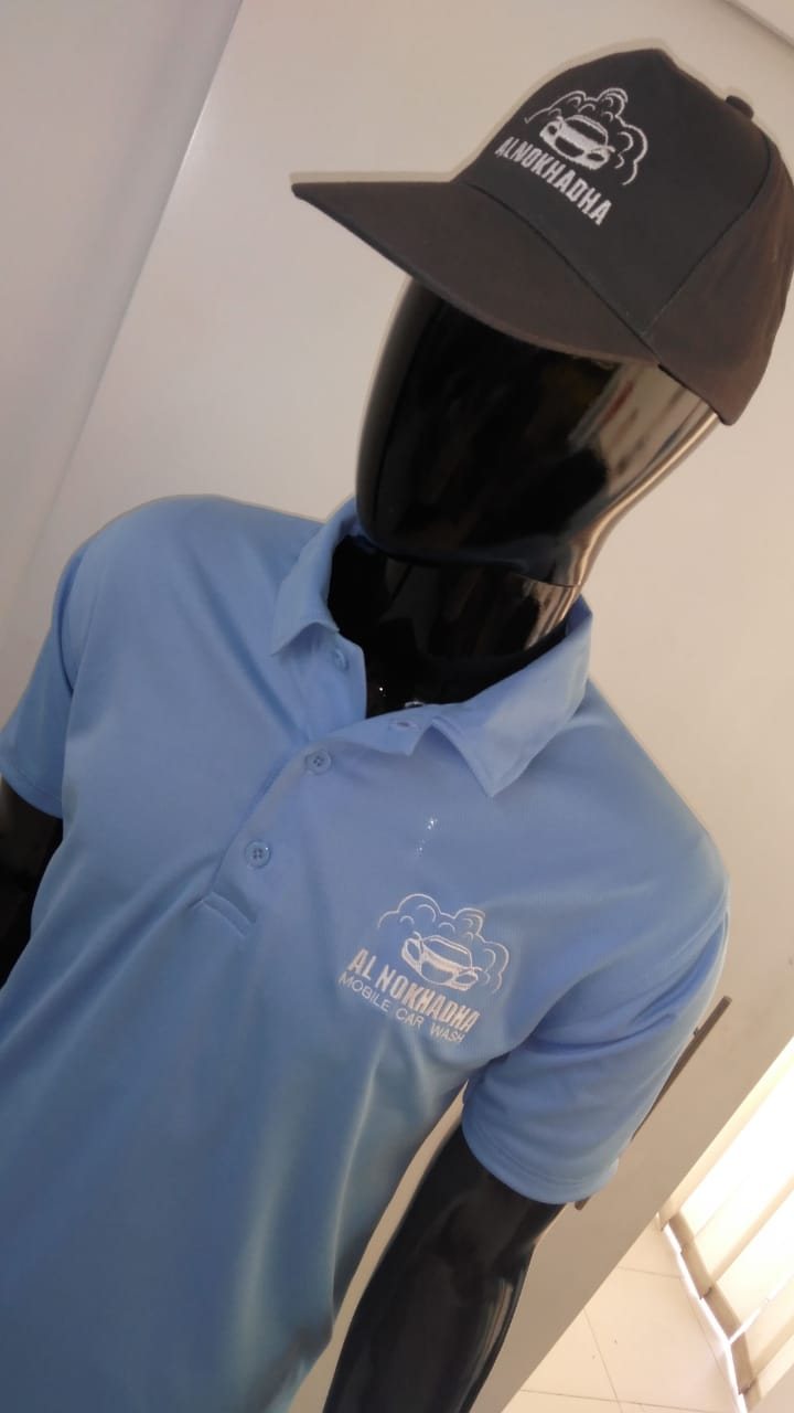 Light-blue polo shirt with a white embroidered logo and a matching dark cap on a mannequin