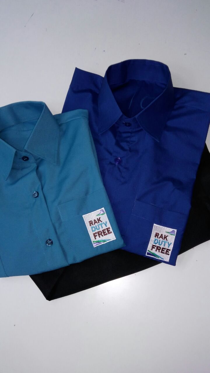 Folded turquoise and royal-blue work shirts with hang tags