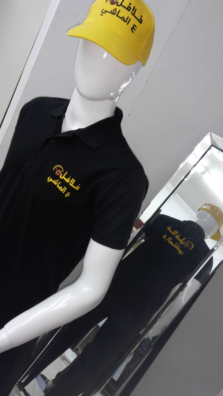 Yellow cap and black polo shirt with an embroidered logo on a mannequin